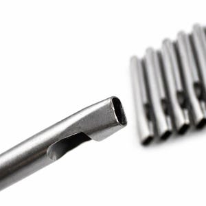 May include: Close-up of several silver-colored metal tubes with a rectangular opening. One tube is in focus, showing a side opening. The tubes are arranged against a white background.