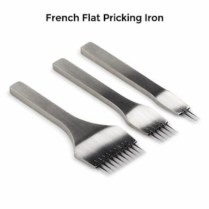 May include: Three silver French flat pricking irons. The tools have a flat, rectangular handle and a series of sharp, pointed tines. The text "French Flat Pricking Iron" is at the top of the image.