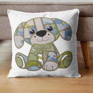 May include: A white throw pillow featuring a patchwork dog design. The dog has large, round eyes, a black nose, and a green bow tie. The patchwork incorporates blue, green, and beige fabrics, creating a whimsical and decorative accent.
