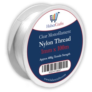 May include: A spool of clear monofilament nylon thread, 1mm thick and 100 meters long. The spool is labeled "Clear Monofilament Nylon Thread 1mm x 100m" and "Approx 40Kg Tensile Strength". The label also includes the website address "www.habercrafts.com" and a barcode.