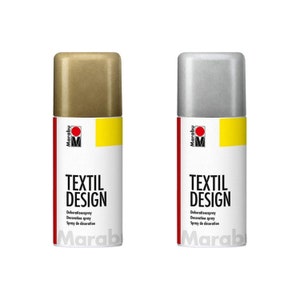 May include: Two spray paint cans, one gold and one silver, with the text "Marabu Textil Design Dekorationsspray Decoration spray Spray de d&eacute;coration" on the label.