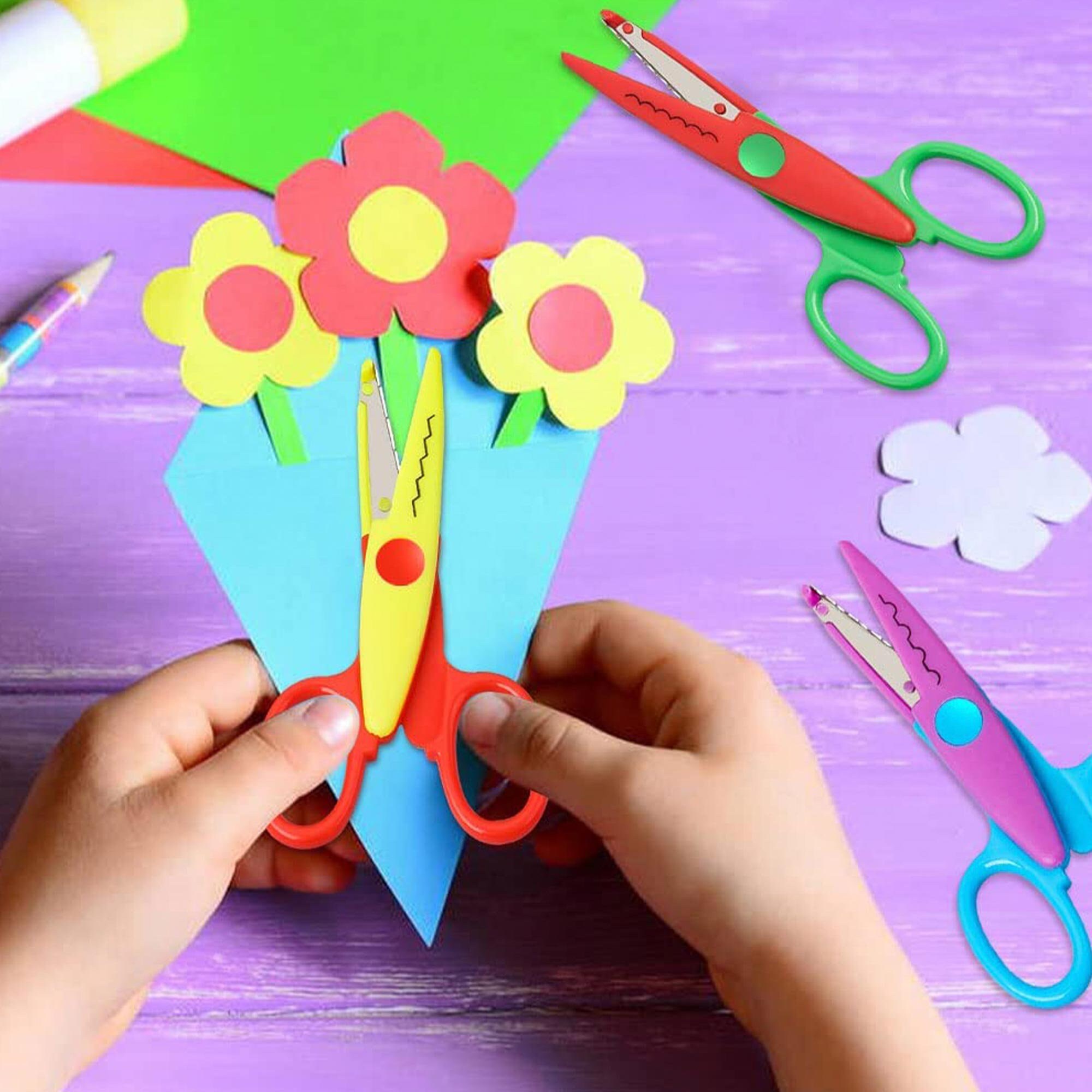 Child holds the scissors and cut out the felt flower. Scissors, hot glue  gun, sheets of felt, decorative pendant with felt butterflies and flowers  Stock Photo by ©OnlyZoia 115559608