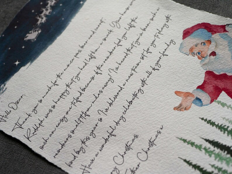 May include: A handwritten letter from Santa Claus with a watercolour illustration of Santa Claus in a red suit and a white beard. The letter is written on a white background with a blue watercolour wash at the top. The letter says "Hello Oscar. Thank you so much for the mince pies beer and carrot. Rudolph was so happy that you had left them a snack. Your hagwats reindeer smelt it from miles away! I've heard that you've been such a kind boy this year so I've delivered a new train set for you to play with. Have a wonderful day celebrating with all of your family. Merry Christmas.  Other Christmas."