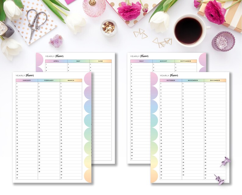 May include: Two yearly planner pages with a white background. The pages have a pastel rainbow color scheme. The text "Yearly Planner" is at the top of each page. The pages are open to January, February, March, April, May, June, July, August, September, October, November, and December.