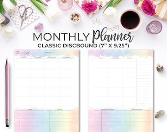 May include: A monthly planner with a watercolour rainbow design. The planner is 7 inches by 9.25 inches and has a classic discbound design. The planner has sections for goals, to do, important dates, and appointments.