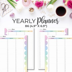 May include: A yearly planner with a pastel rainbow design. The planner is B6 size, measuring 4.9" x 6.9". The pages are divided by month, with space for notes. The text "YEARLY Planner" is at the top of each page.