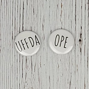 May include: Two white round buttons with black text. The left button says "UFF DA" and the right button says "OPE".