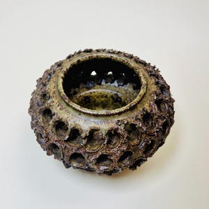 Vintage Brutalist style candle holder by Frank Milo Tromborg from the 1970s, featuring a textured, rustic design with circular cutouts, perfect for wabi sabi and vintage décor enthusiasts.