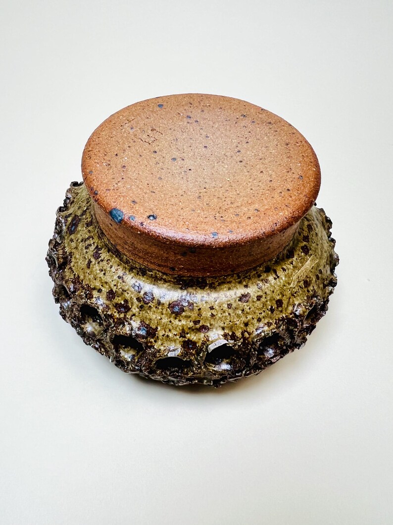 Vintage Brutalist style candle holder by Frank Milo Tromborg from the 1970s, featuring a textured, rustic design with circular cutouts, perfect for wabi sabi and vintage décor enthusiasts.