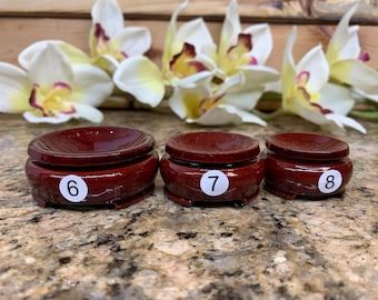May include: Three wooden display stands for crystals or other small objects. The stands are brown and have a circular top. The stands are labeled with the numbers 6, 7, and 8.