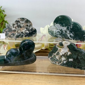 May include: Four green and white agate cloud shaped stones on a clear acrylic display stand. The stones are numbered 4, 5, 6, and 7.