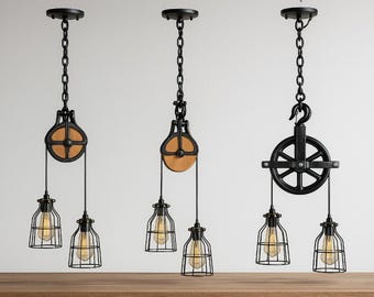May include: Three industrial-style pendant lights with black metal pulley and cage designs. Each light features a chain, a pulley with a wooden wheel, and a cage-style light fixture with a visible bulb. The lights are suspended from the ceiling.