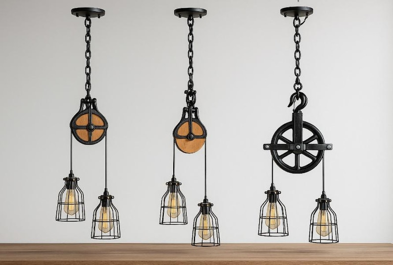 May include: Three industrial pendant lights with black metal pulley and cage designs. Each light features a chain, a pulley with a wooden wheel, and a cage-style light fixture with a visible bulb. The lights are suspended from the ceiling.
