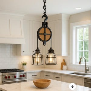 May include: An industrial-style pendant light fitting with a black pulley system and a wooden wheel. Two caged light bulbs hang below. The kitchen has white cabinets, a stainless steel stove, and a wooden bowl on the counter.