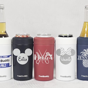 May include: Five personalized FrostBuddy drink coolers in different colors and designs. The coolers are white, black, red, white, and blue. Each cooler has a different design, including a Mickey Mouse head, scissors, a bow, and a pineapple. The text on the coolers reads "FrostBuddy", "Erica", "Monika", "Valerie", and "Jennifer".