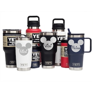 May include: A collection of YETI Rambler tumblers, bottles, and can insulators in various colors including black, white, red, and navy. Several items feature a white Mickey Mouse-style silhouette graphic with custom names like Nicki, Vicki, and Melissa.