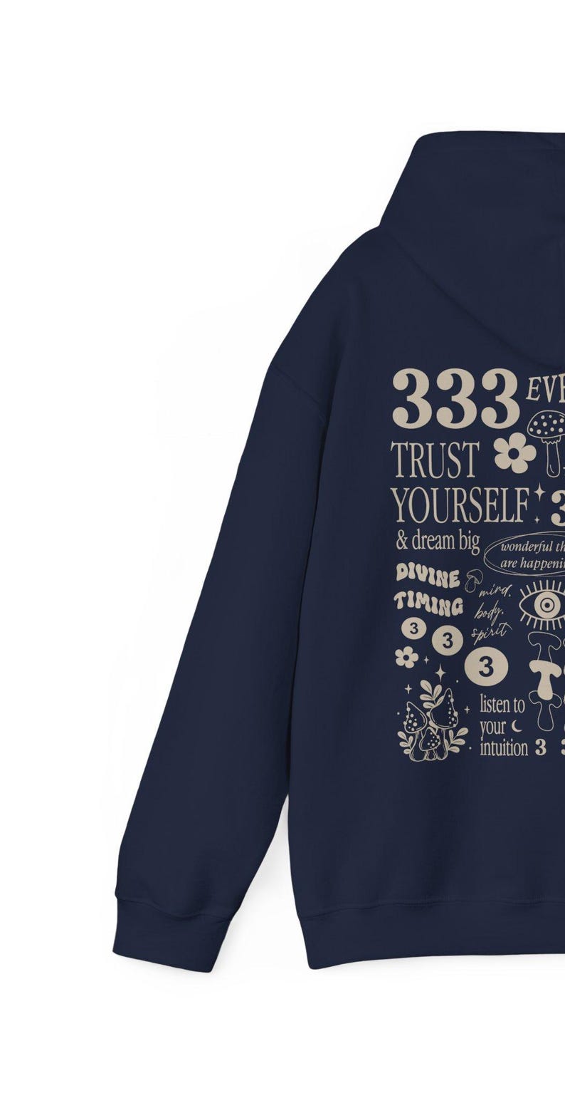 May include: Navy blue hoodie with a white graphic print featuring the text "333 EVE TRUST YOURSELF & dream big DIVINE TIMING 333 listen to your intuition 3" with mushroom and flower illustrations.