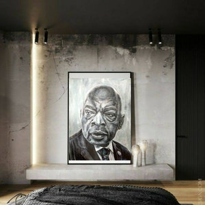 以下が含まれることがあります： コンクリートの壁に、スーツとネクタイを着た男性の白黒肖像画が飾られています。コンクリート製の棚の上に、銀色のランプが2つ置かれています。部屋はモダンなスタイルで装飾されています。