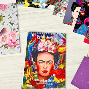 May include: A colorful calendar featuring Frida Kahlo with parrots and flowers. The calendar is titled "Calendar 2023 by Alina Dalinina".