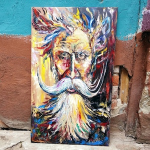 May include: A colorful oil painting of a man with a long white beard and mustache. The painting is done in a vibrant style with lots of brushstrokes. The man's face is expressive and his eyes are intense. The background is a mix of colors and textures.