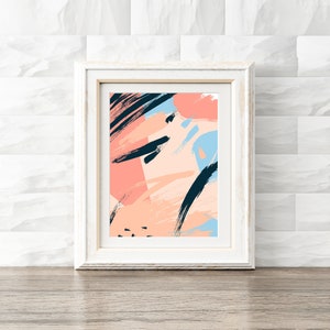 May include: Abstract art print in a white frame. The print features a colourful design with pink, peach, blue, and black brushstrokes.