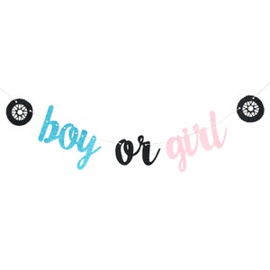 May include: A gender reveal party banner with black tire-shaped decorations and the words "boy or girl" in blue, black, and pink glitter.