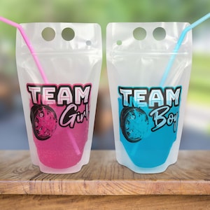 May include: Two clear plastic pouches with straws, one pink and one blue. The pouches have the text "TEAM Girl" and "TEAM Boy" printed on them.