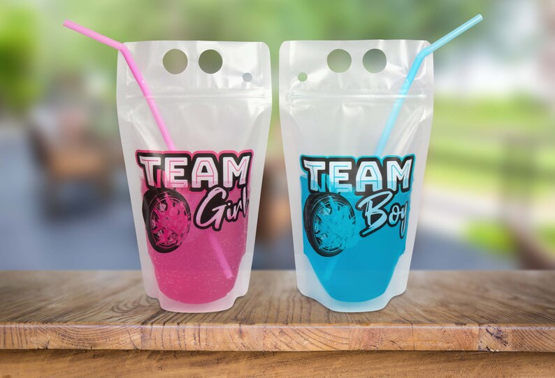 May include: Two clear plastic pouches with straws, one pink and one blue. The pouches have the text "TEAM Girl" and "TEAM Boy" printed on them.