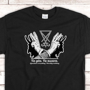 May include: Black t-shirt with a white graphic of a pentagram with two hands reaching up. The text below reads "No gods. No masters. Question everything. Worship nothing."