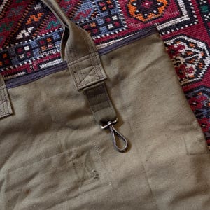 May include: A set of three ceramic mugs with a speckled, matte finish in cream, light brown, and dark brown. Each mug has a minimalist design and a rounded handle.