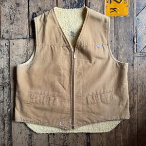 Vintage Carhartt Duck Canvas Sherpa gefütterte Sunfaded Arbeitsweste. Hergestellt in den USA, Größe XL.