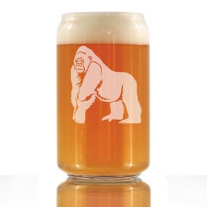 May include: A clear glass beer can with a frosted gorilla design. The can is filled with a light amber colored beer with a white head.