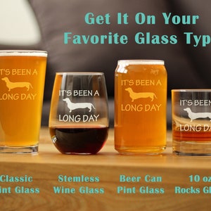 May include: Four different glass types with the text "It's been a long day" and a dachshund silhouette printed on them. The glasses are a classic pint glass, a stemless wine glass, a beer can pint glass, and a 10 oz rocks glass.