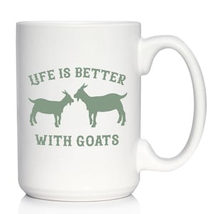 May include: White ceramic coffee mug with a green design that says "Life is better with goats" and features two goats facing each other.