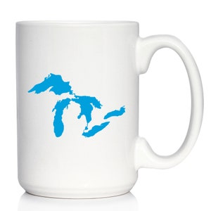 May include: White ceramic coffee mug with a blue outline of the Great Lakes on the front.