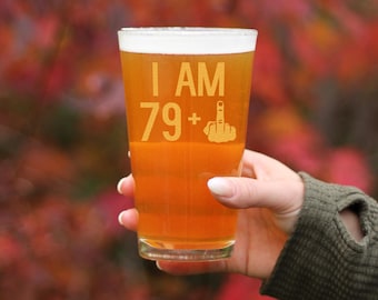 May include: A clear glass beer stein with the text "I AM 79+" and a middle finger graphic.