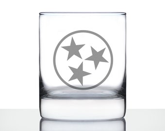 May include: A clear glass tumbler with a gray etched design of the state of Tennessee's three stars logo.