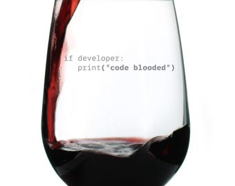 May include: A stemless wine glass with the text "if developer: print("code blooded")" printed on the side. The glass is being filled with red wine, with the liquid partially filling the glass.