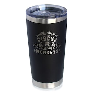 May include: Black stainless steel travel mug with a silver lid. The mug has the text "Not My Circus Not My Monkeys" engraved on the side.