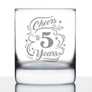 May include: A clear glass tumbler with the text "Cheers to 5 Years" etched on the front. The text is in a decorative script font with stars and swirls.
