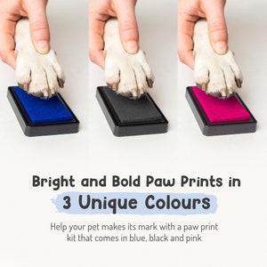 May include: A paw print ink pad set with three ink colors: blue, black, and pink. The ink pads are in a black plastic frame. The ink pads are used to make paw prints of pets.