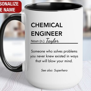 May include: White ceramic mug with a black handle and black rim. The mug has a black and white design that reads "CHEMICAL ENGINEER Noun (n.) Taylor Someone who solves problems you never knew existed in ways that will blow your mind. See also: Superhero"