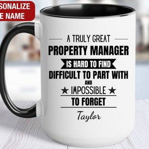 May include: White ceramic coffee mug with a black handle and black rim. The mug has a black and white design that reads "A truly great property manager is hard to find, difficult to part with and impossible to forget." The name "Taylor" is printed below the text.