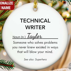 May include: A white ceramic Christmas ornament with gold hanging string. The ornament has the text "TECHNICAL WRITER" and a definition. The name "Taylor" is written below the definition. The ornament is surrounded by Christmas tree branches.