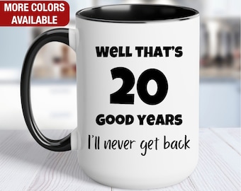 May include: White ceramic coffee mug with a black handle and black rim. The mug has black text that reads "Well that's 20 good years I'll never get back."