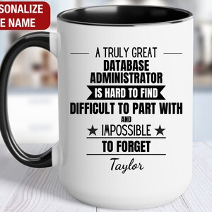 May include: White ceramic coffee mug with a black handle and black rim. The mug has a black and white design that reads "A truly great database administrator is hard to find and impossible to forget." The name "Taylor" is printed below the text.