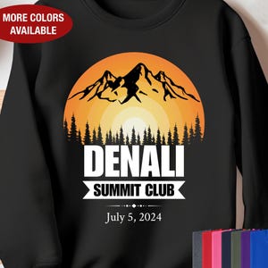 May include: Black sweatshirt with a graphic of a mountain range with a sunset behind it. The text "Denali Summit Club" and "July 5, 2024" is printed below the graphic.