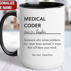 May include: White ceramic mug with a black handle and black rim. The mug has a black and white design that reads "MEDICAL CODER Noun (n.) Taylor Someone who solves problems you never knew existed in ways that will blow your mind. See also: Superhero"