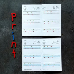 May include: Two pages from a children's workbook with tracing exercises for the letters 's', 'u', 'c', 'o', and 'a'. The pages are filled with dotted lines for tracing and have red and green dots to guide the child.