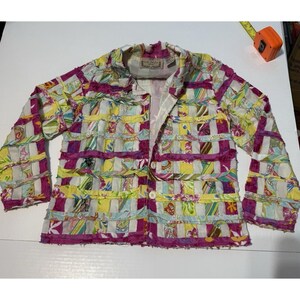 May include: A colorful patchwork jacket with a button closure. The jacket features a mix of floral and geometric patterns in shades of pink, yellow, green, and white. The jacket has long sleeves and a collar.